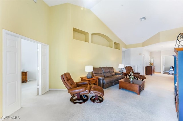 living room featuring light carpet and high vaulted ceiling