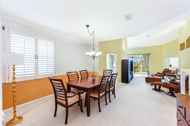 dining room featuring light carpet and a notable chandelier