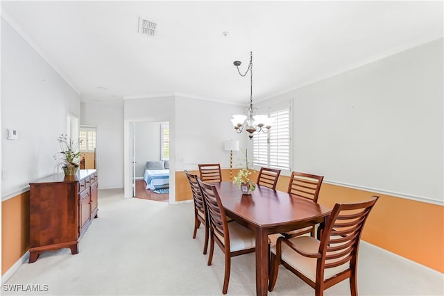 dining space featuring an inviting chandelier, light colored carpet, a healthy amount of sunlight, and crown molding