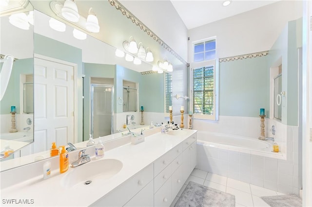 bathroom with tile patterned flooring, vanity, and separate shower and tub