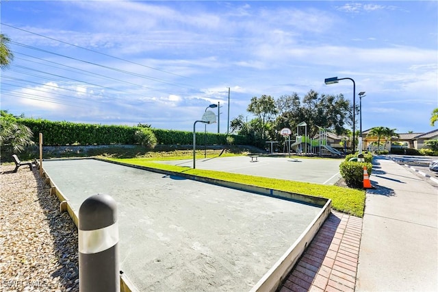 view of community featuring basketball court and a playground