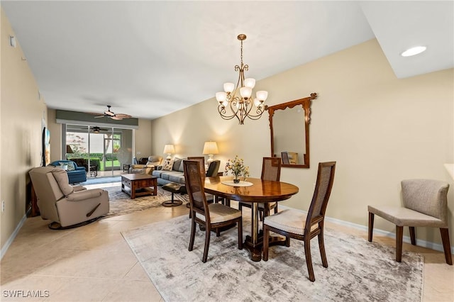 tiled dining space featuring ceiling fan with notable chandelier