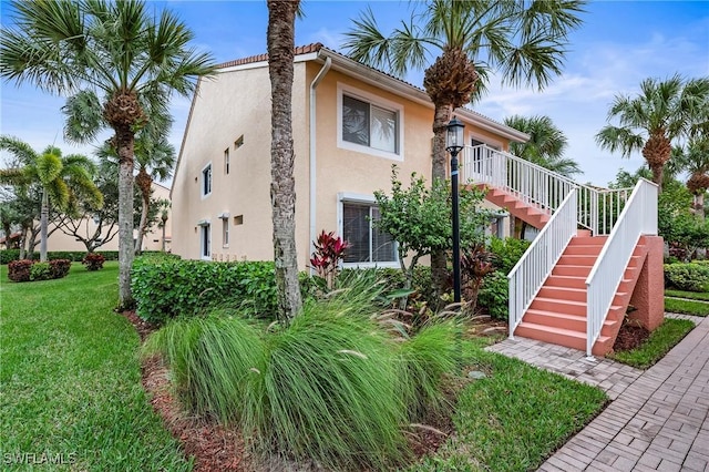 view of side of home featuring a lawn