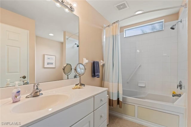 bathroom featuring tile patterned flooring, shower / bath combo, and vanity