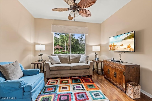 living room featuring ceiling fan and wood-type flooring