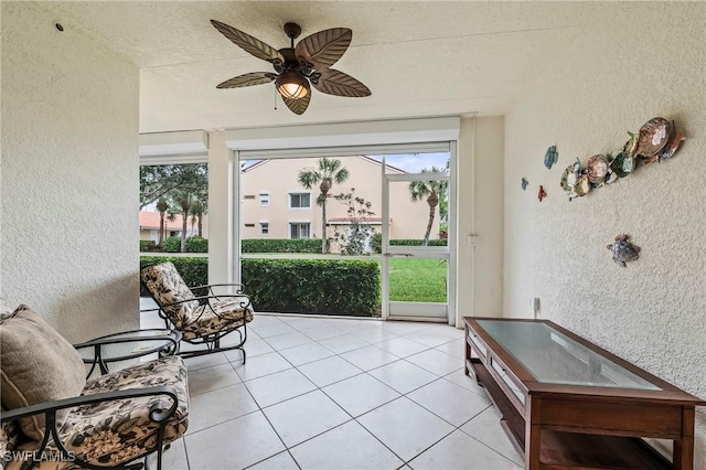 sunroom featuring ceiling fan