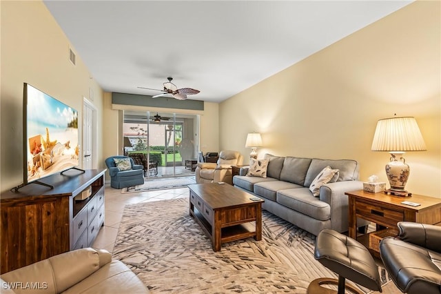 tiled living room with ceiling fan