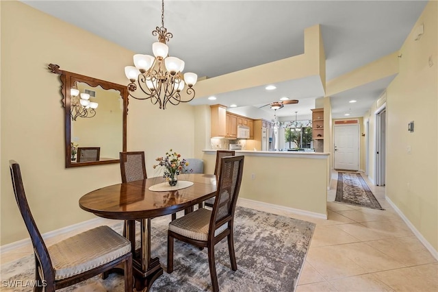 tiled dining area with a chandelier