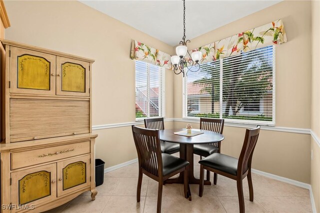 dining space with light tile patterned floors and a notable chandelier