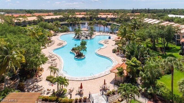 view of pool featuring a patio and a water view