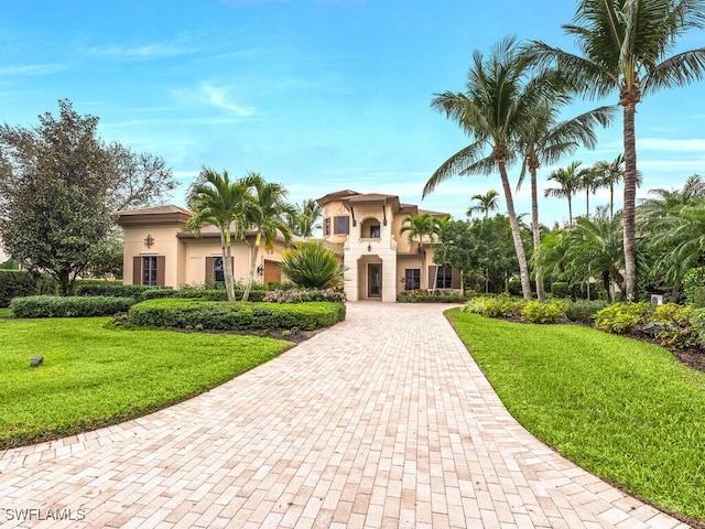 mediterranean / spanish house with a front yard and stucco siding