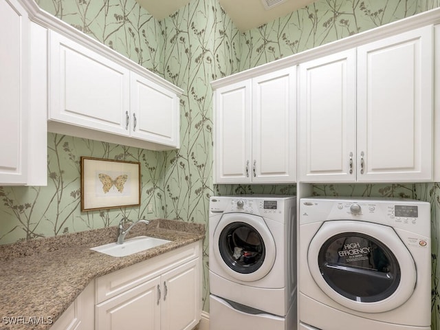 28732 La Caille Dr, Naples, FL 34119 - laundry room with wallpapered walls, a sink, cabinet space, and washing machine and clothes dryer