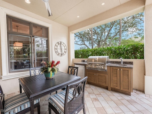 28732 La Caille Dr, Naples, FL 34119 - view of patio / terrace featuring grilling area, a sink, outdoor dining area, a ceiling fan, and an outdoor kitchen