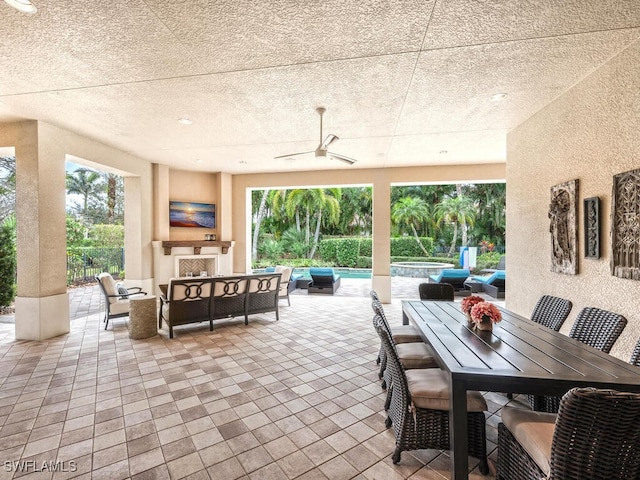 28732 La Caille Dr, Naples, FL 34119 - view of patio with a ceiling fan, an outdoor living space with a fireplace, a pool with connected hot tub, and outdoor dining area