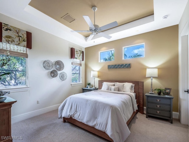 28732 La Caille Dr, Naples, FL 34119 - bedroom with baseboards, visible vents, light carpet, and a raised ceiling