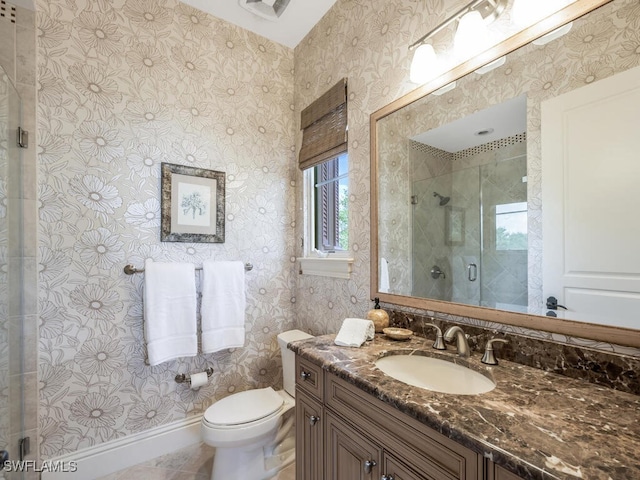 28732 La Caille Dr, Naples, FL 34119 - bathroom featuring vanity, toilet, baseboards, wallpapered walls, and a stall shower