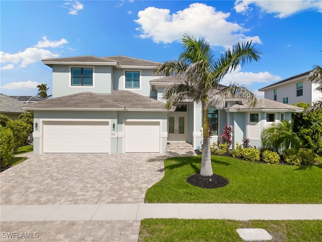 view of front of home featuring a garage and a front yard