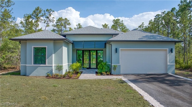 view of front of house with a garage and a front lawn