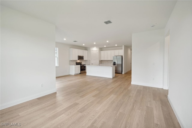 unfurnished living room with light hardwood / wood-style flooring