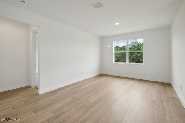 spare room with light wood-type flooring