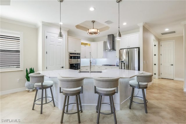 kitchen featuring visible vents, wall chimney range hood, ornamental molding, and appliances with stainless steel finishes