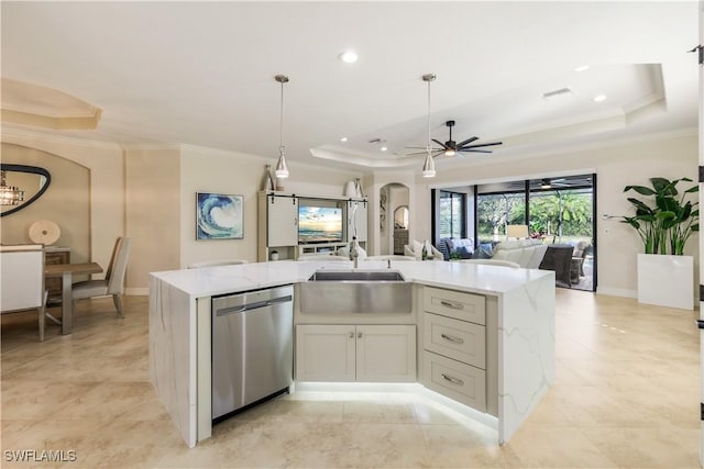 kitchen featuring arched walkways, a raised ceiling, dishwasher, an island with sink, and open floor plan