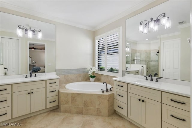 ensuite bathroom with ornamental molding, a stall shower, a sink, and a bath