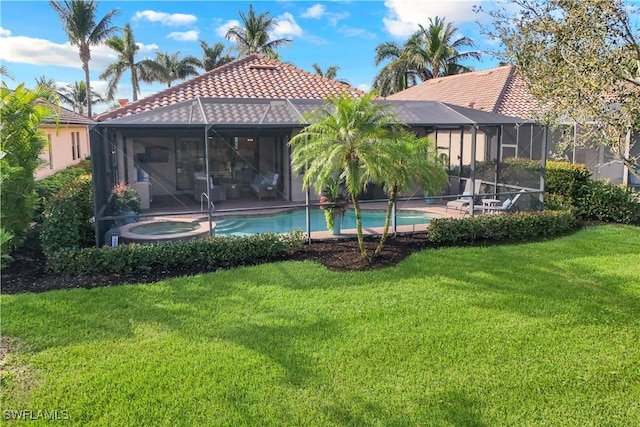 back of property with an outdoor pool, a tile roof, an in ground hot tub, a lanai, and a yard