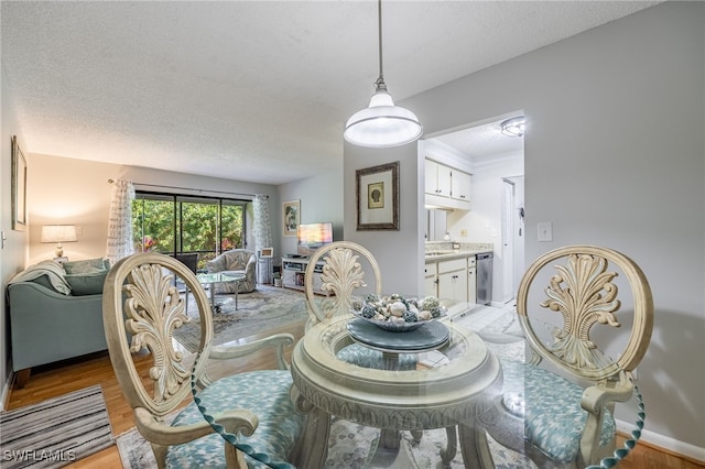 dining area featuring hardwood / wood-style floors and a textured ceiling