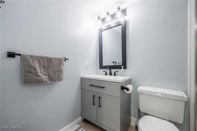 bathroom with vanity, toilet, and tile patterned flooring