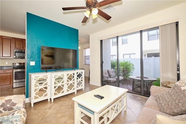 tiled living room with ceiling fan