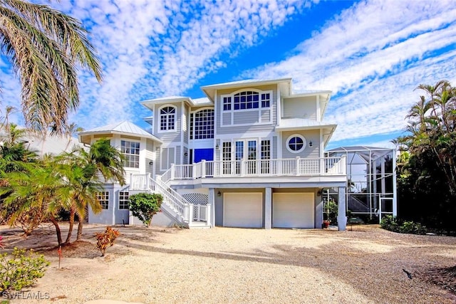 view of front of home with a garage and a lanai