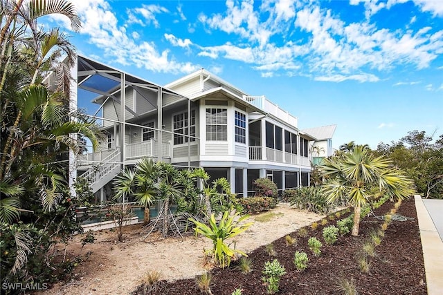 rear view of house featuring a lanai