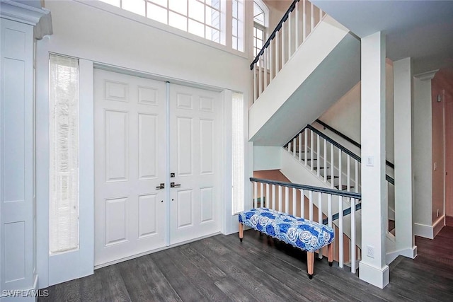 foyer entrance featuring dark hardwood / wood-style flooring and a high ceiling