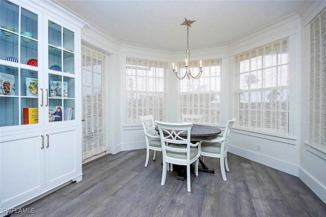 dining area with crown molding, dark hardwood / wood-style flooring, and a notable chandelier