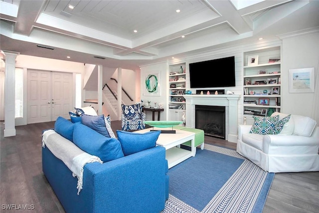 living room featuring coffered ceiling, dark hardwood / wood-style flooring, decorative columns, and built in features