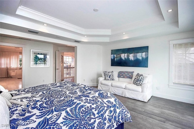 bedroom featuring multiple windows, ornamental molding, dark hardwood / wood-style flooring, and a tray ceiling