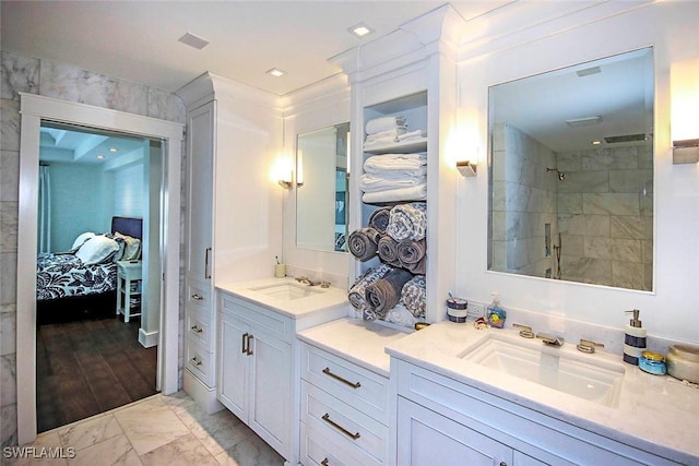 bathroom featuring a tile shower and vanity