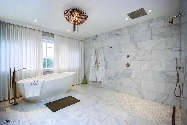 bathroom featuring tile walls and plus walk in shower