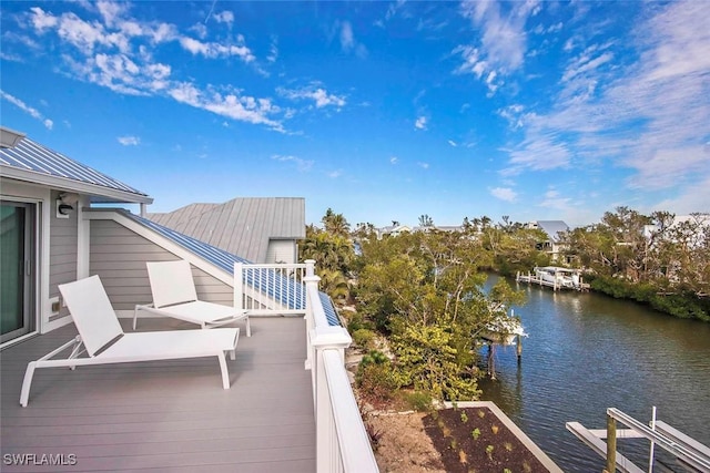 deck with a water view and a boat dock