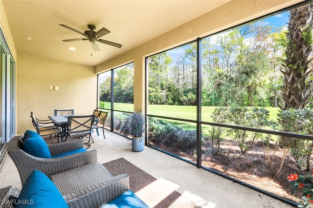 sunroom featuring ceiling fan