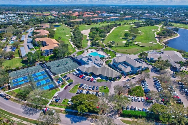 drone / aerial view with view of golf course, a water view, and a residential view