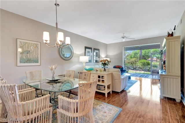 dining room featuring wood finished floors and ceiling fan with notable chandelier