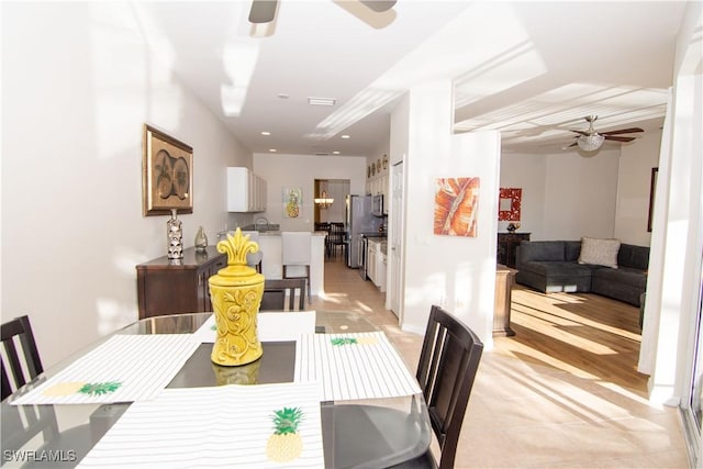 tiled dining area with ceiling fan