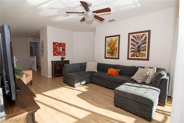 living room featuring ceiling fan and light wood-type flooring