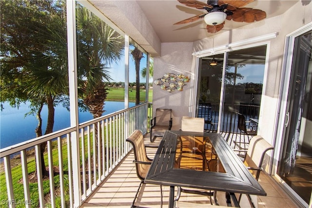 balcony with a water view and ceiling fan