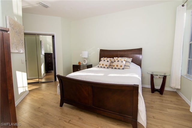 bedroom featuring light hardwood / wood-style floors and a closet