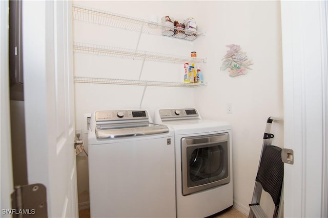 clothes washing area with washing machine and dryer