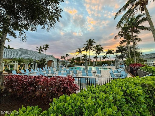 pool at dusk with a patio