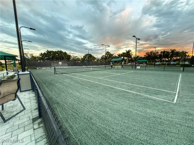 view of tennis court featuring fence